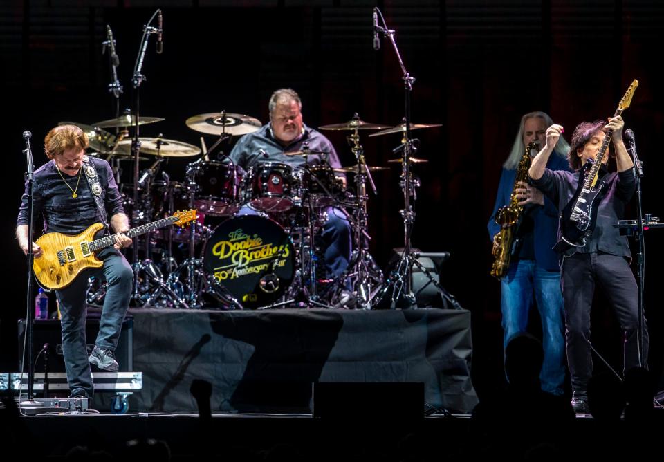 Doobie Brothers members Tom Johnston (left), Ed Toth (drums) and John McFee perform at Acrisure Arena in Palm Desert, Calif., Thursday, Dec. 15, 2022. 