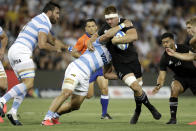 New Zealand's Sam Cane is tackled by the defence during the Tri-Nations rugby test between Argentina and the All Blacks in Newcastle, Australia, Saturday, Nov. 28, 2020. (AP Photo/Rick Rycroft)