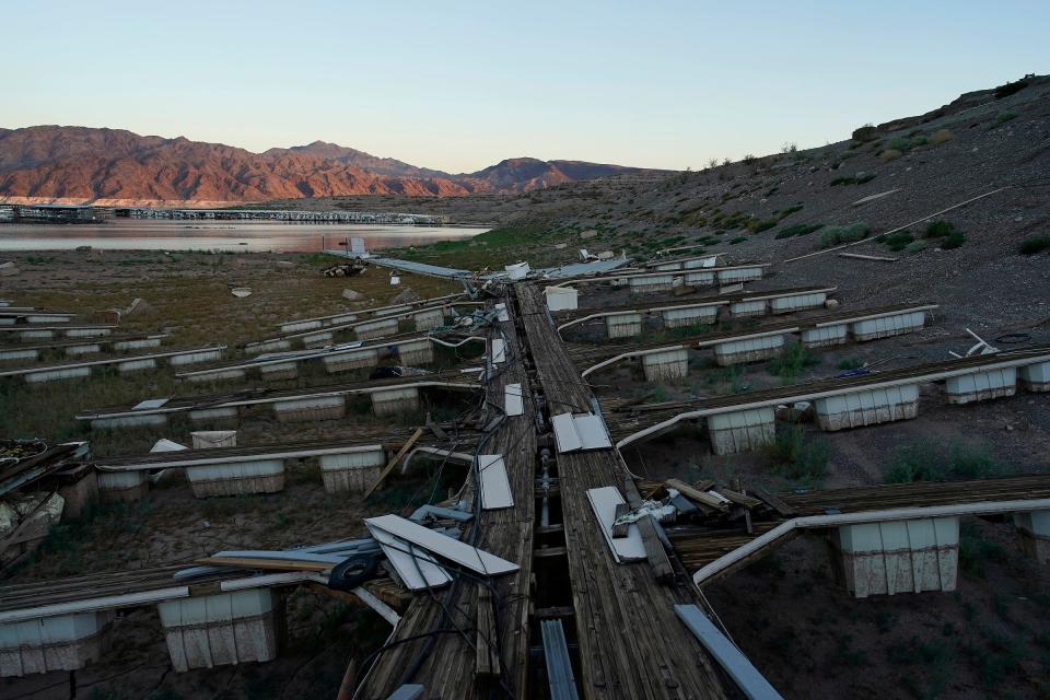 Floating boat docks sit on dry ground as water levels have dropped near the Callville Bay Resort & Marina in the Lake Mead National Recreation Area, Tuesday, Aug. 30, 2022, near Boulder City, Nev. As water levels plummet, calls for reduced use have often been met with increased population growth.