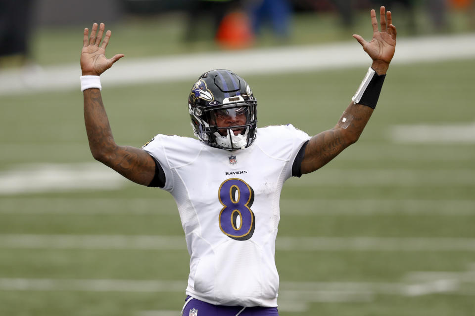 Baltimore Ravens quarterback Lamar Jackson (8) celebrates after running back J.K. Dobbins (27) ran in for a touchdown against the Cincinnati Bengals during the second half of an NFL football game, Sunday, Jan. 3, 2021, in Cincinnati. (AP Photo/Aaron Doster)