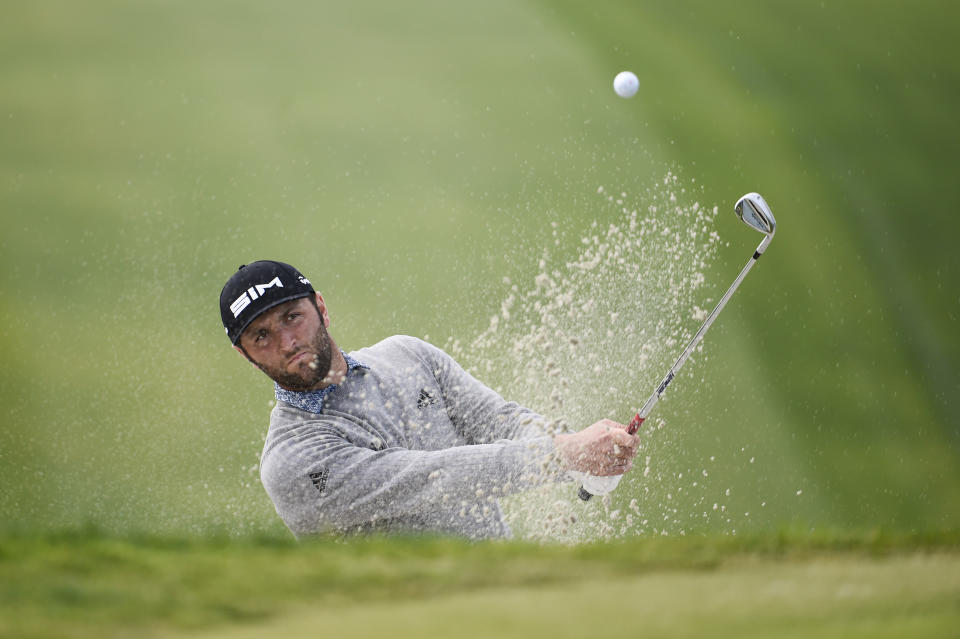 Jon Rahm of Spain hits out of the bunker on the 13th hole of the South Course at Torrey Pines Golf Course during the third round of the Farmers Insurance golf tournament Saturday, Jan. 25, 2020, in San Diego. (AP Photo/Denis Poroy)