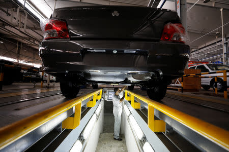 An employee works on a car inside the Saipa Syria Factory in the industrial city of Hassia in Homs, Syria September 9, 2018. Picture taken September 9, 2018. REUTERS/Omar Sanadiki