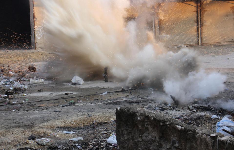 A mortar fired by Free Syrian Army fighters explodes, injuring fighters nearby, in Aleppo