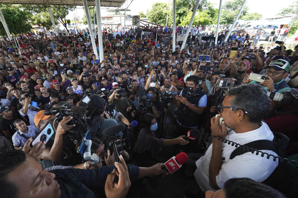 Luis Garcia Villagran, coordinator of the Center for Human Dignification A.C., talks during an assembly with migrants, many from Central America and Venezuela, sheltering in a sports complex in Huixtla, Chiapas state, Mexico, Wednesday, June 8, 2022. The group left Tapachula on Monday, tired of waiting for their status in a region with little work and far from their ultimate goal of reaching the United States. (AP Photo/Marco Ugarte)