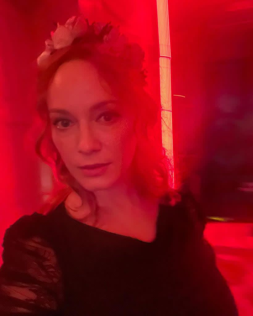 christina hendricks wearing black lace in selfie lit by red light