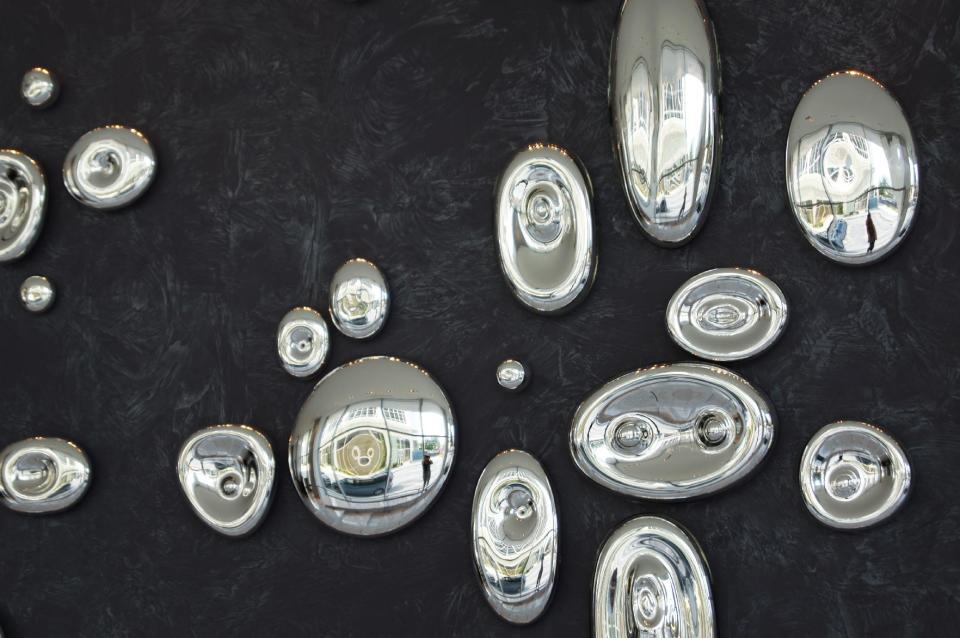 This publicity photo provided by Buenoglass.com shows the silver series, composed of a mirrored material known as mercury glass, from Bueno Glass. The smooth pebble shapes represent sound waves, or scientific particles. (AP Photo/Buenoglass.com)