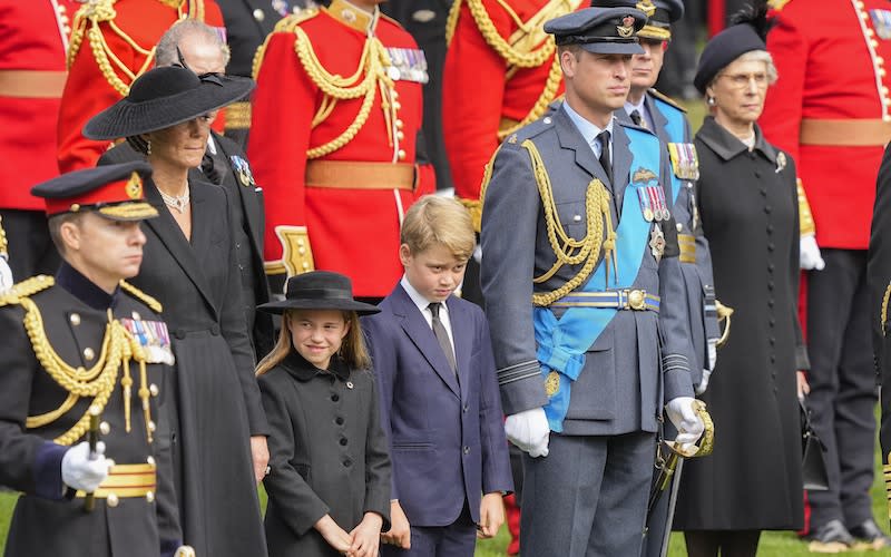 Prince William, from right, Prince George, Princess Charlotte and Kate, Princess of Wales, watch as the coffin of the queen is placed into the hearse following the state funeral service.