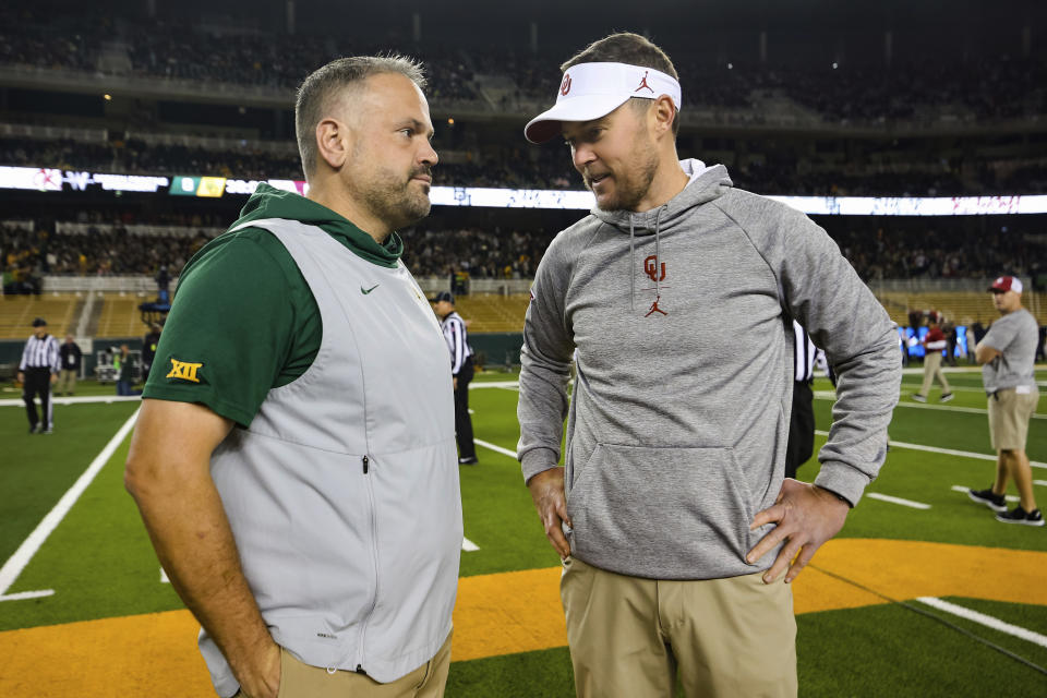 FILE - In this Nov. 16, 2019, file photo, Baylor head coach Matt Rhule, left, and Oklahoma head coach Lincoln Riley talk at midfield prior to an NCAA college football game in Waco, Texas. Rhule and Riley took over their teams under drastically different circumstances. Now they will coach against each other in the Big 12 championship game. (AP Photo/Ray Carlin, File)