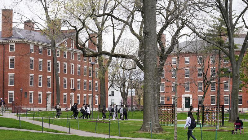 Students walk through Harvard Yard on April 27, 2022, on the campus of Harvard University in Cambridge, Mass. On Monday, July 24, 2023, the U.S. Department of Education opened an investigation into Harvard University’s policies on legacy admissions.