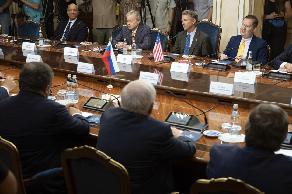 Top from left: a member of the Senate of the legislative Assembly of the state of Texas Peter Hettler, Texas Sen. Don Huffines, Sen. Rand Paul and his communications director Sergio Gor attend a meeting with Russian lawmakers in Moscow, Russia, Monday, Aug. 6, 2018. Paul said he has invited Russian lawmakers to visit the United States to help foster inter-parliamentary contacts. (AP Photo/Pavel Golovkin)