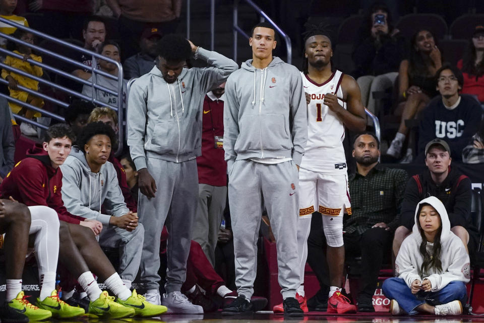 Southern California's Zach Brooker, Boogie Ellis, Bronny James, Kobe Johnson and Isaiah Collier, from left, watch from the bench during the second half of the team's loss to UC Irvine in an NCAA college basketball game Tuesday, Nov. 14, 2023, in Los Angeles. (AP Photo/Ryan Sun)