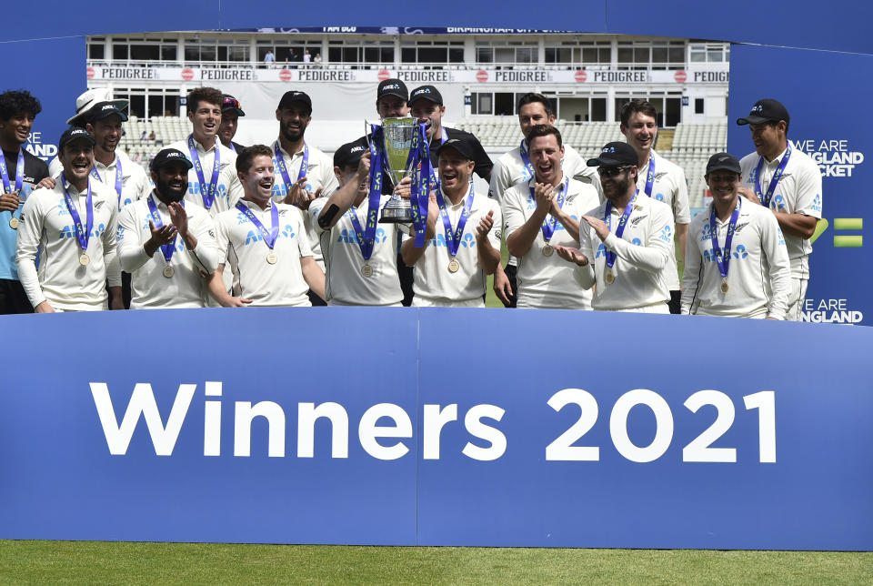 New Zealand players celebrate with the winners trophy after their win in the second cricket test match between England and New Zealand at Edgbaston in Birmingham, England, Sunday, June 13, 2021. New Zealand won the series 1-0. (AP Photo/Rui Vieira)