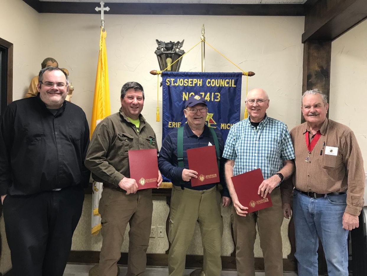 Rev. Mark Prill (left), chaplain of St. Joseph Council 7413, Knights of Columbus, and District Deputy Ron Dressel (far right) presented plaques to Rick Spotts, Peter Dusseau and Tom Merce. Spotts and his wife, Maureen (not shown), were named Family of the Year for the council and Dusseau and Merce were named co-Knights of the Year for the council.
