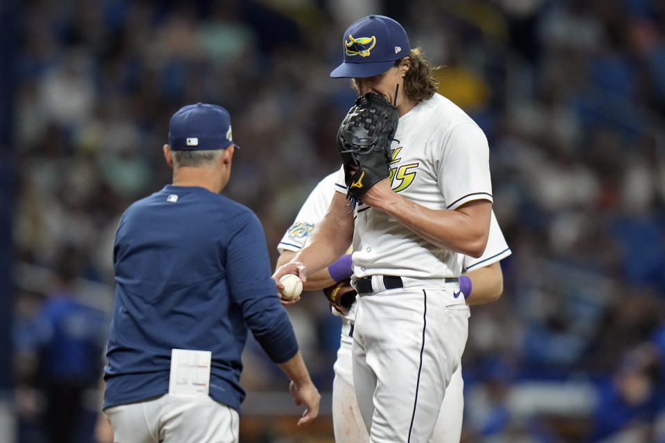 Tampa Bay Rays starting pitcher Tyler Glasnow, right, hands the ball to manager Kevin Cash after being taken out of the game against the Toronto Blue Jays during the sixth inning of a baseball game Friday, Sept. 22, 2023, in St. Petersburg, Fla. (AP Photo/Chris O'Meara)