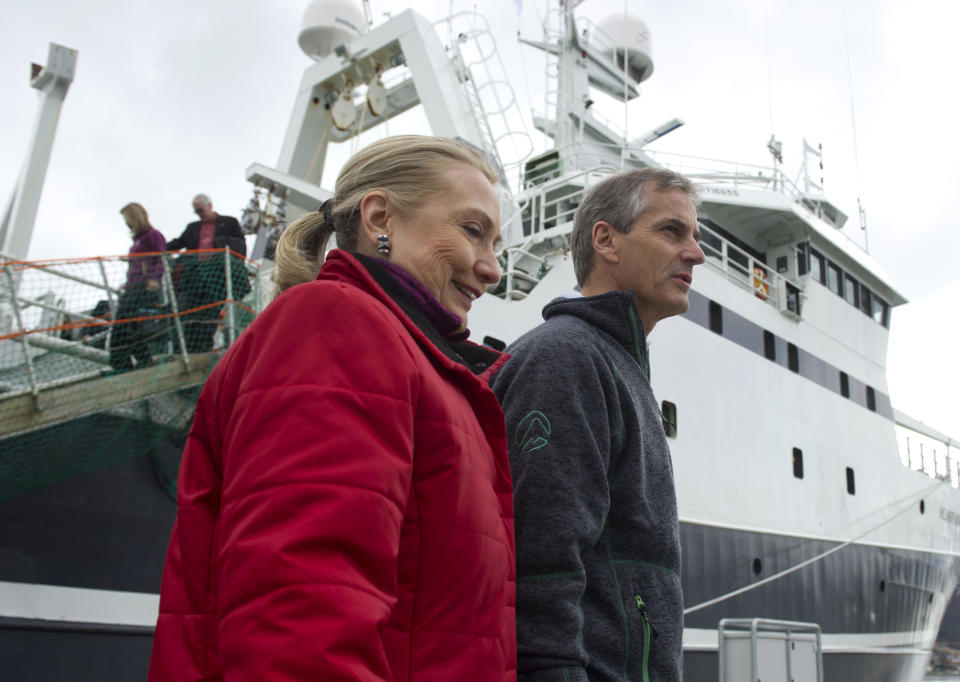U.S. Secretary of State Hillary Rodham Clinton and Norway's Minister of Foreign Affairs Jonas Gahr Stoere, right, walk on the dock after taking a boat tour on the Arctic Research vessel Helmer Hanssen on a fjord, near the northern Norwegian city of Tromso, Norway, Saturday, June 2, 2012. Clinton is trekking north of the Arctic Circle, a region that could become a new international battleground for resources. (AP Photo/Saul Loeb, Pool)