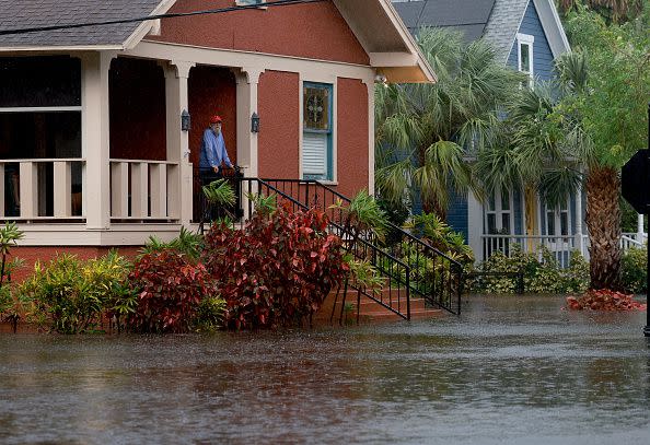 TARPON SPRINGS, FLORIDA - AUGUST 30: Steve Odom stands on the porch of his home that is surrounded by flood waters caused by Hurricane Idalia passing offshore on August 30, 2023 in Tarpon Springs, Florida. Hurricane Idalia is hitting the Big Bend area on the Gulf Coast of Florida.  (Photo by Joe Raedle/Getty Images)