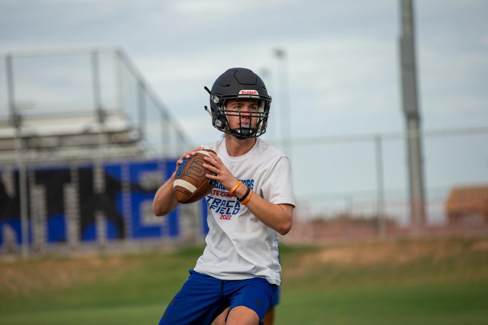 Quarterback Gage Baker throws the ball to a teammate during practice at Paradise Honors High School football field in Surprise, Ariz., on July 27, 2022.