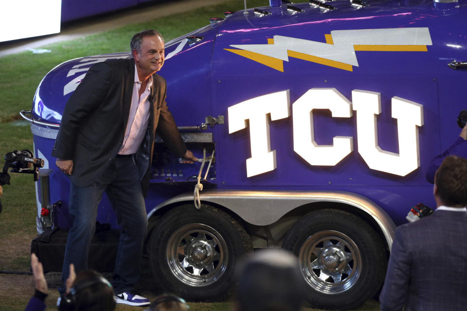 New TCU head football coach Sonny Dykes blows the touchdown horn after being introduced at Amon G. Carter Stadium at Texas Christian University, Monday, Nov. 29, 2021, in Fort Worth, Texas. (AP Photo/Richard W. Rodriguez)