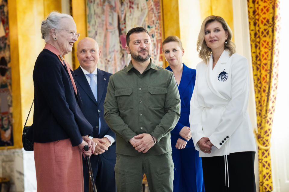 Queen Margrethe II of Denmark, left, speaks with Ukrainian President Volodymyr Zelenskyy, center, and his wife First Lady Olena Zelenska, right, accompanied by speaker of the Danish Parliament Soeren Gade, second left, and Danish Prime Minister Mette Frederiksen in the Danish Parliament in Copenhagen, Denmark Monday, Aug. 21, 2023. (Martin Sylvest/Ritzau Scanpix via AP)