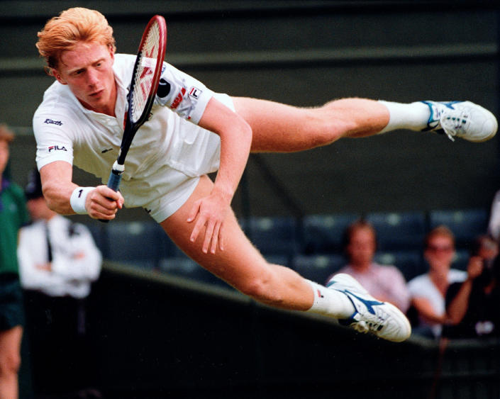 FILE - Defending champion Boris Becker of Germany flies through the air to return a shot from Australia's Wally Masur during their second round match at Wimbledon on Wednesday, June 27, 1990. Caulkin, a retired Associated Press photographer has died. He was 77 and suffered from cancer. Known for being in the right place at the right time with the right lens, the London-based Caulkin covered everything from the conflict in Northern Ireland to the Rolling Stones and Britain’s royal family during a career that spanned four decades. (AP Photo/Dave Caulkin, File)
