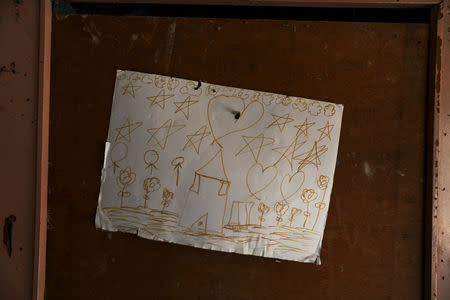 A drawing of a house hangs on the wall of an empty hut after its inhabitants left the Roma shanty town of El Gallinero, on the outskirts of Madrid, Spain, September 25, 2018. REUTERS/Susana Vera