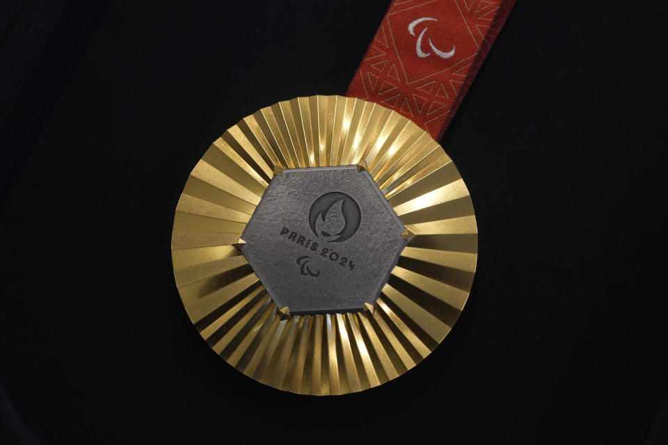 The Paris 2024 Paralympic gold medal is presented to the press, in Paris, Thursday, Feb. 1, 2024. A hexagonal, polished piece of iron taken from the Eiffel Tower is being embedded in each gold, silver and bronze medal that will be hung around athletes' necks at the July 26-Aug. 11 Paris Games and Paralympics that follow. (AP Photo/Thibault Camus)