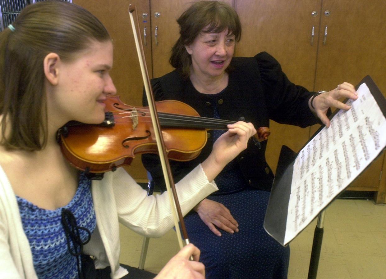 In 2000, Gloria Coates visited Wausau West High School to talk about her career in musical composition. She's helping fresman Jessica Steinmetz with a piece.