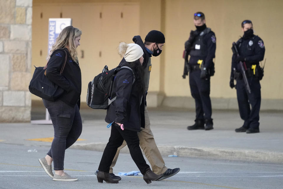 FBI officials walk to the Mayfair Mall, Friday, Nov. 20, 2020, in Wauwatosa, Wis. Multiple people were shot Friday afternoon at the mall. Wauwatosa Mayor Dennis McBride says in a statement that a suspect remains at large after the shooting at Mayfair Mall. (AP Photo/Nam Y. Huh)