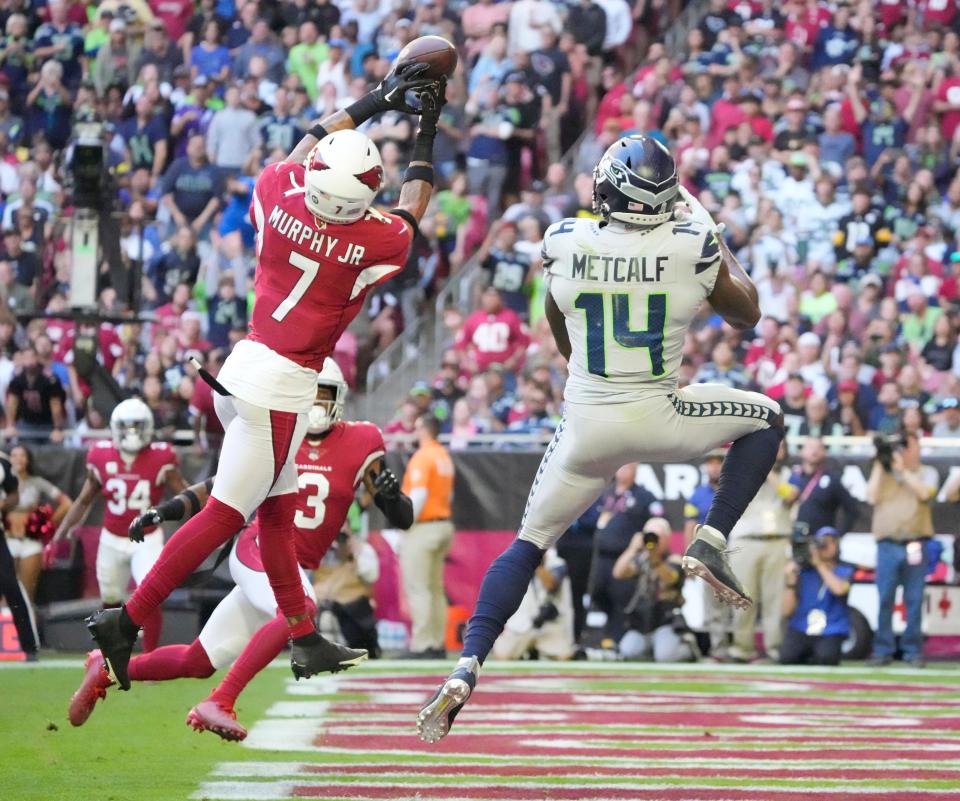 Nov 6, 2022; Phoenix, Ariz., United States;  Arizona Cardinals cornerback Byron Murphy Jr. (7) breaks up a pass intended for Seattle Seahawks wide receiver DK Metcalf (14) during the second quarter at State Farm Stadium.