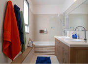 <body> <p>Life with kids comes with a lot of “stuff.” Shuffling small bodies, shampoos, soaps, bath toys, towels, and the rest of the whatnot poses a logistical challenge. The <a rel="nofollow noopener" href=" http://www.bobvila.com/articles/diy-bench/?bv=yahoo" target="_blank" data-ylk="slk:long bench;elm:context_link;itc:0;sec:content-canvas" class="link ">long bench</a> in this modern kids' bathroom gives everybody a place to sit while drying off (or supervising!) and also serves as a landing place for the myriad slippers, PJs, and toys required at bath time.</p> <p><strong>Related: <a rel="nofollow noopener" href=" http://www.bobvila.com/slideshow/15-diy-storage-ideas-to-help-corral-your-kids-clutter-44313/?bv=yahoo" target="_blank" data-ylk="slk:15 DIY Storage Ideas to Help Corral Your Kids' Clutter;elm:context_link;itc:0;sec:content-canvas" class="link ">15 DIY Storage Ideas to Help Corral Your Kids' Clutter</a> </strong> </p> </body>