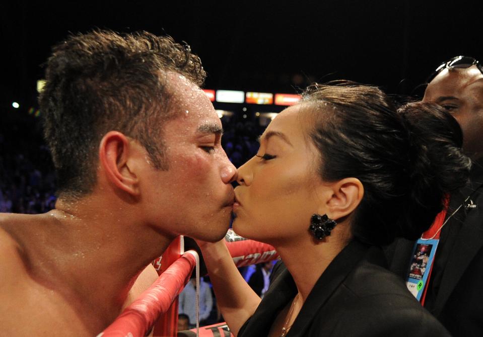 CARSON, CA - OCTOBER 13: Nonito Donaire of The Phillipines gets a kiss from wife Rachel Marcial after his ninth round TKO of Toshioka Nishioka of Japan during the WBO Super Bantamweight Title fight at The Home Depot Center on October 13, 2012 in Carson, California. (Photo by Harry How/Getty Images)