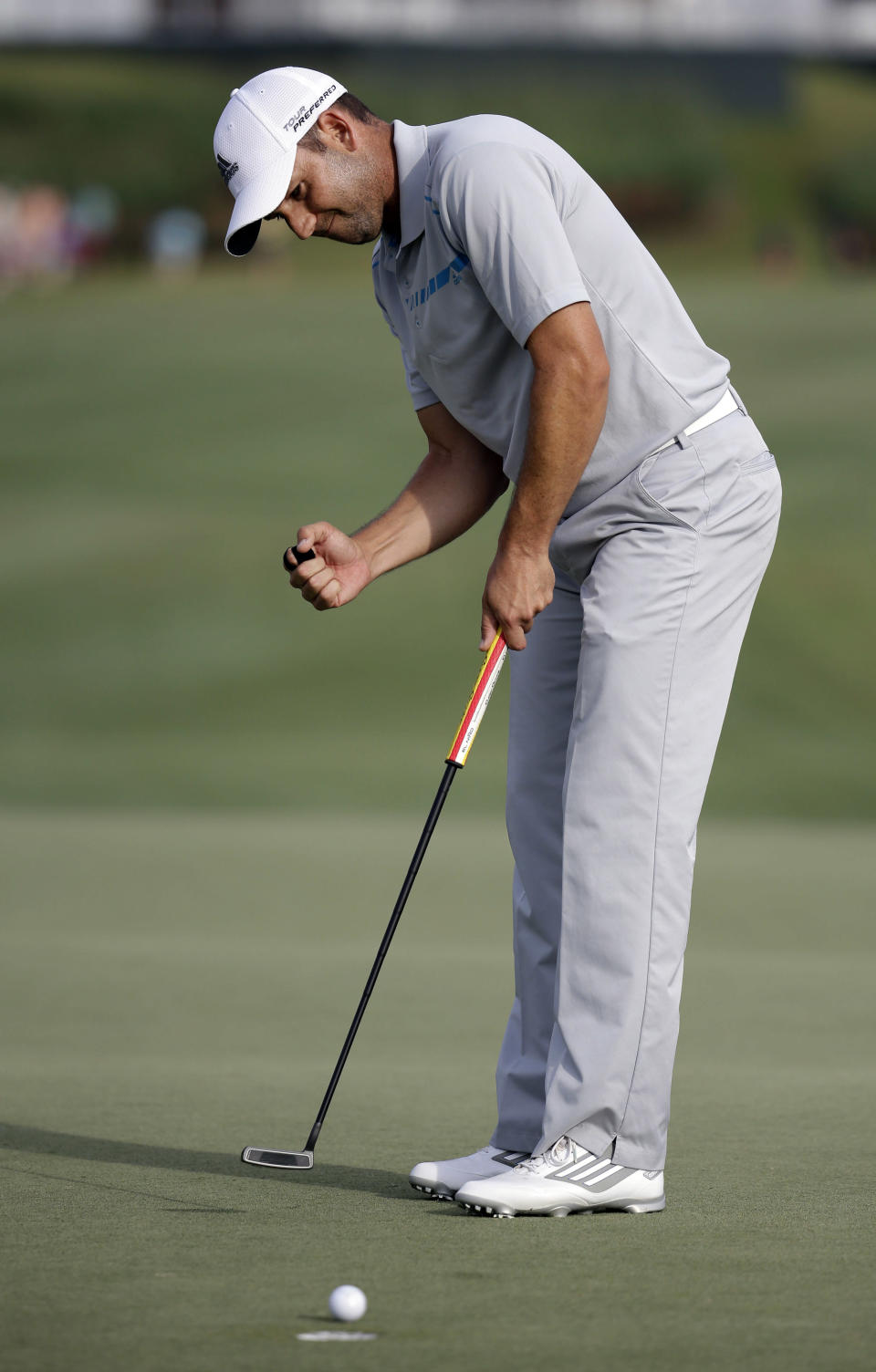Sergio Garcia, of Spain, watches as his ball makes par on the 18th hole during the third round of The Players championship golf tournament at TPC Sawgrass, Saturday, May 10, 2014, in Ponte Vedra Beach, Fla. (AP Photo/Lynne Sladky)