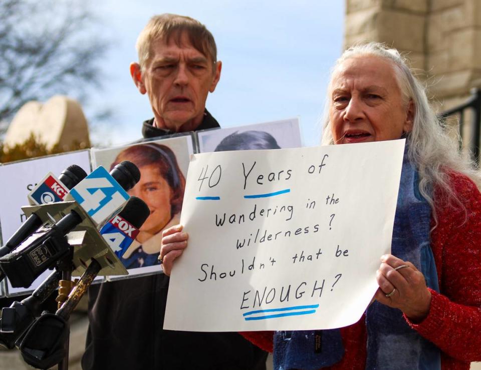 Dee Ann Miller, a member of the Survivors Network of those Abused by Priests, holds a sign that reads “40 years of wandering in the wilderness? Shouldn’t that be enough?” Thursday in Kansas City, Kansas.