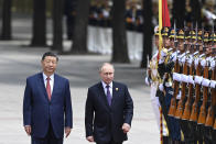 Chinese President Xi Jinping, left, and Russian President Vladimir Putin review the honor guard during an official welcome ceremony in Beijing, China, Thursday, May 16, 2024. (Sergei Bobylev, Sputnik, Kremlin Pool Photo via AP)