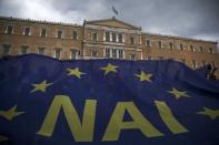 The word 'Yes' in Greek is seen on a banner during a pro-Euro rally in front of the parliament building, in Athens, Greece, June 30, 2015. REUTERS/Marko Djurica