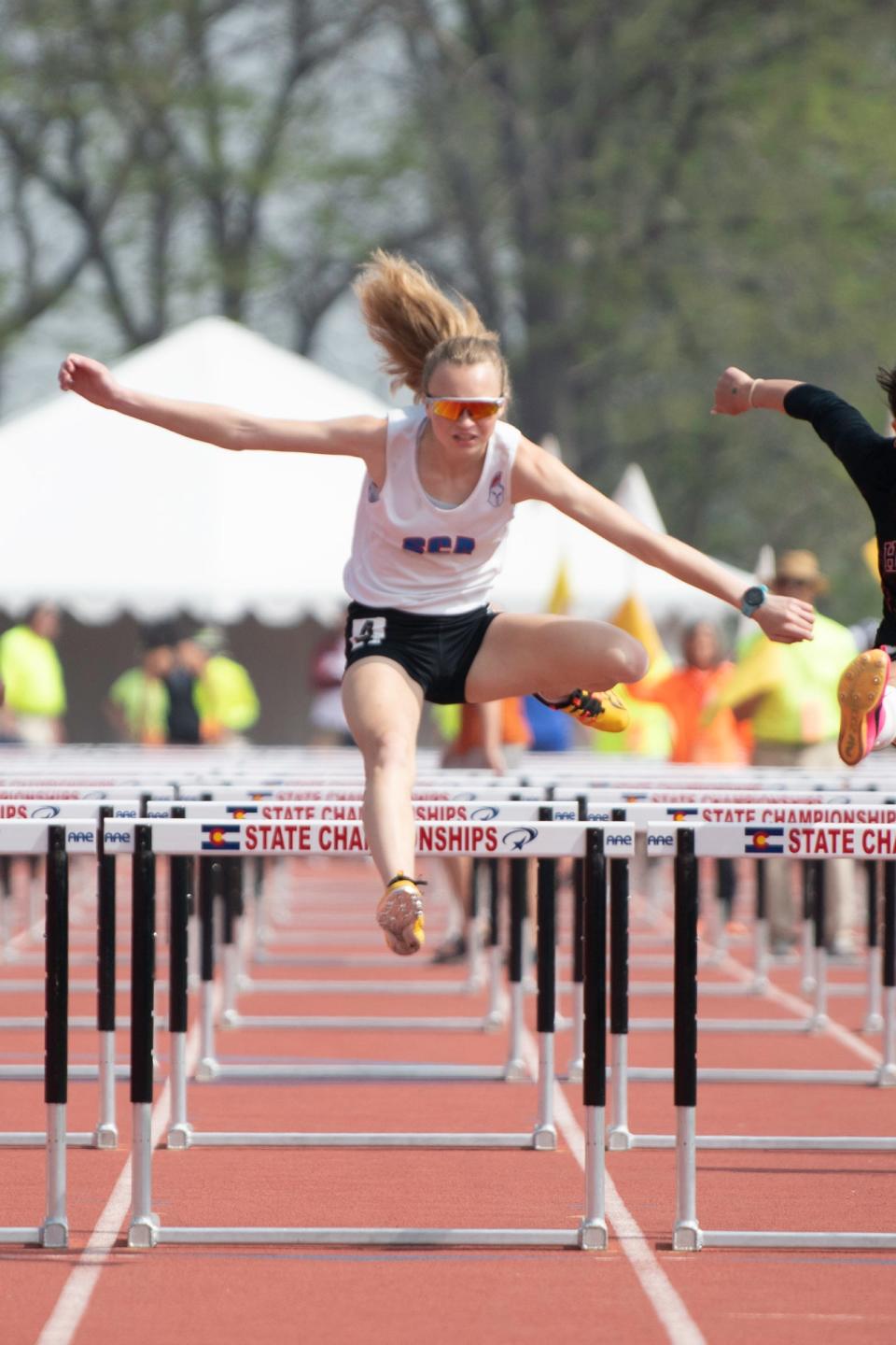 Kaitlyn Pearson of Swallows Charter Academy comes down the home stretch in the Class 2A girls 100-meter hurdle final on day three of the CHSAA track and field state meet at Jeffco Stadium on May 20, 2023.