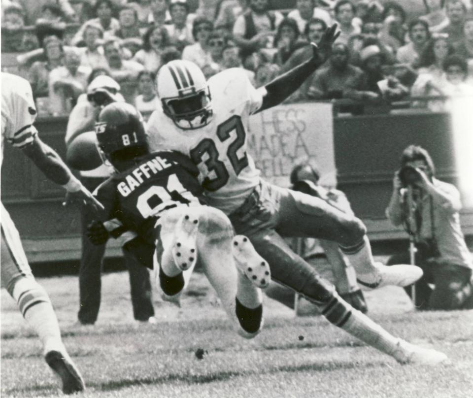 Houston Oilers defensive back Vernon Perry hits a New York Jets receiver in a football game in 1978.
