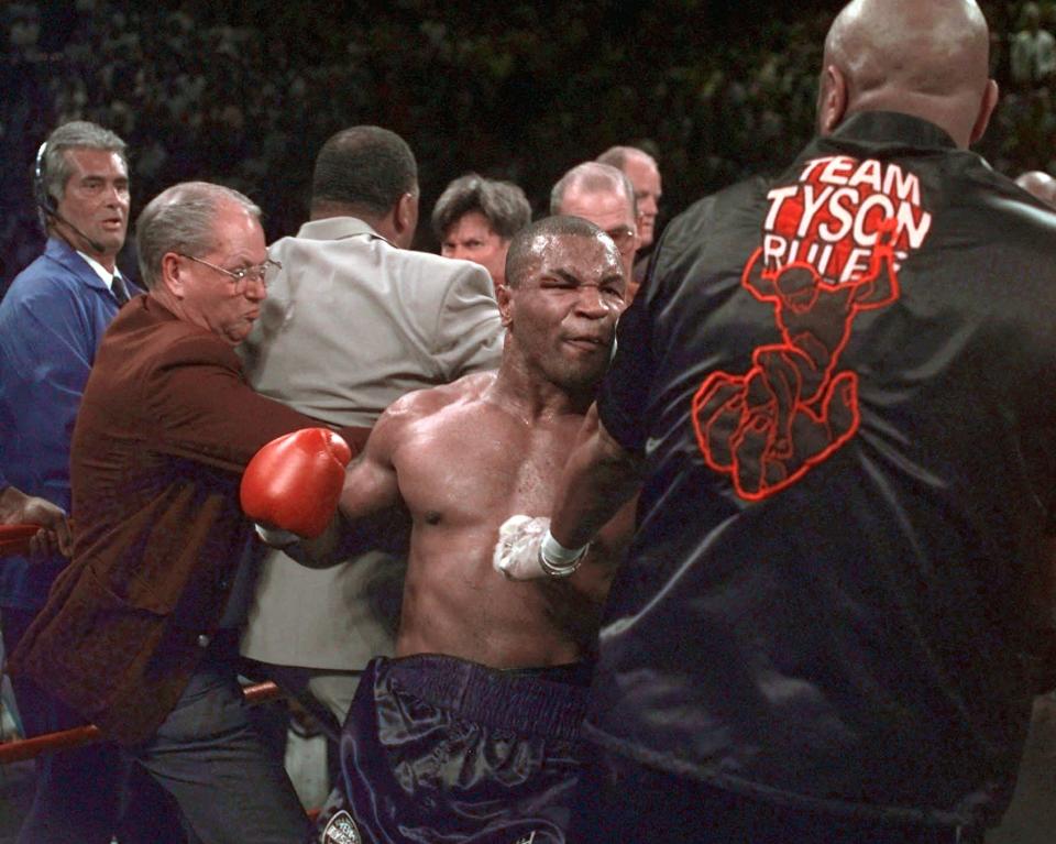 <p>Mike Tyson continues to battle in the ring after his fight against Evander Holyfield was stopped after Tyson bit Holyfield on both ears, in the third round of their WBA Heavyweight match Saturday, June 28, 1997, at the MGM Grand in Las Vegas. Tyson was disqualified and Holyfield retains his title.(AP Photo/Mark J. Terrill) </p>