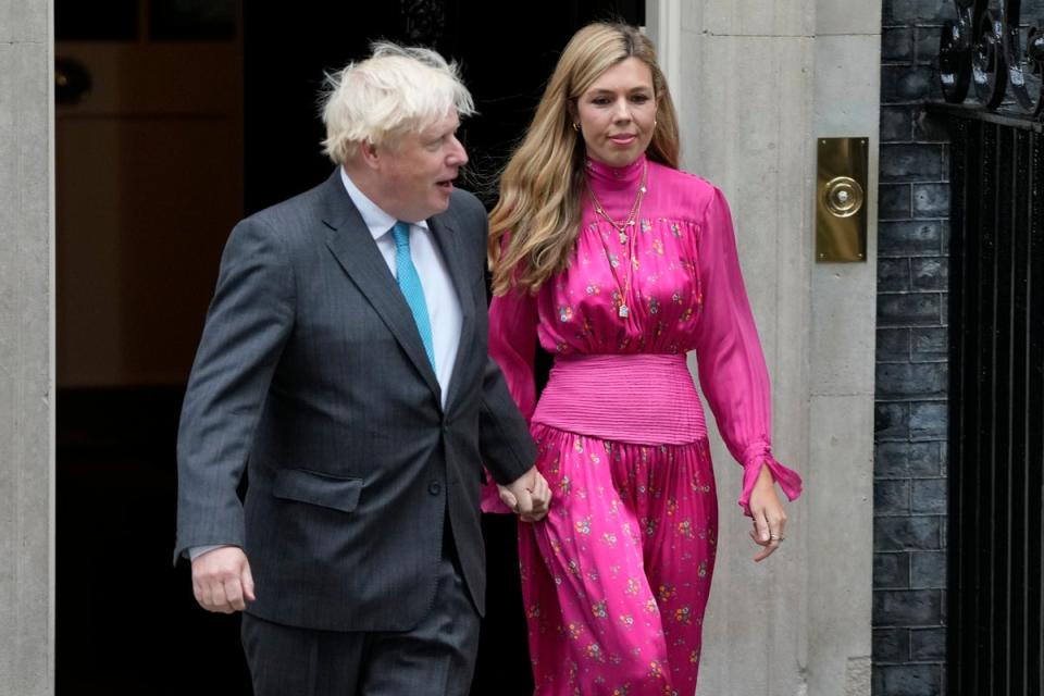 Outgoing British Prime Minister Boris Johnson arrives with his wife Carrie to speak outside Downing Street in London, Tuesday, Sept. 6 (AP)