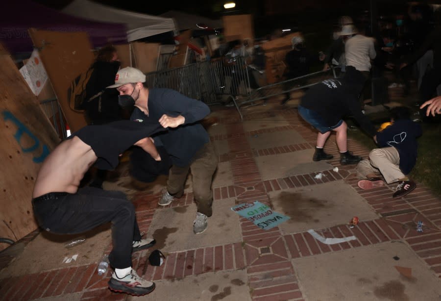 LOS ANGELES, CALIFORNIA – May 1: Pro-Palestinian protestors and pro-Israeli supporters clash at an encampment at UCLA early Wednesday morning. (Wally Skalij/Los Angeles Times via Getty Images)