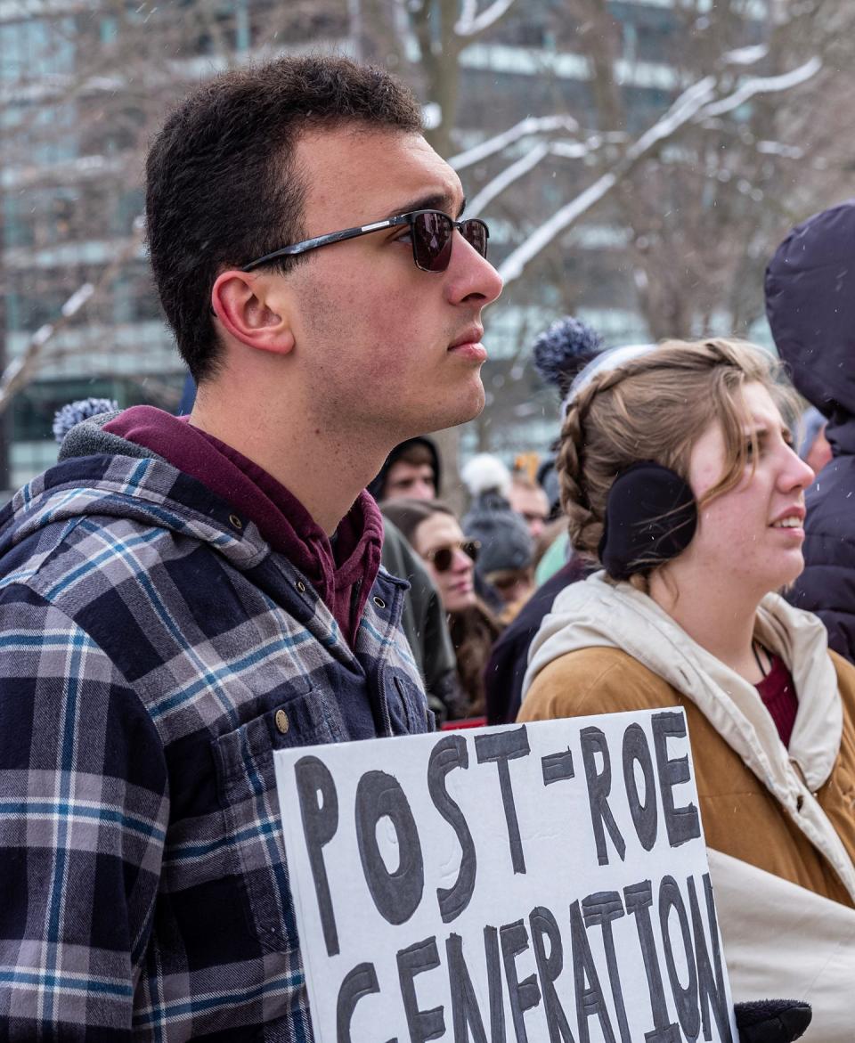 Michigan State University student Samuel Lucido holds a sign declaring he is a post-Roe generation member at the Roe v. Wade Memorial March at and around the state Capitol Saturday, Jan. 28, 2023.