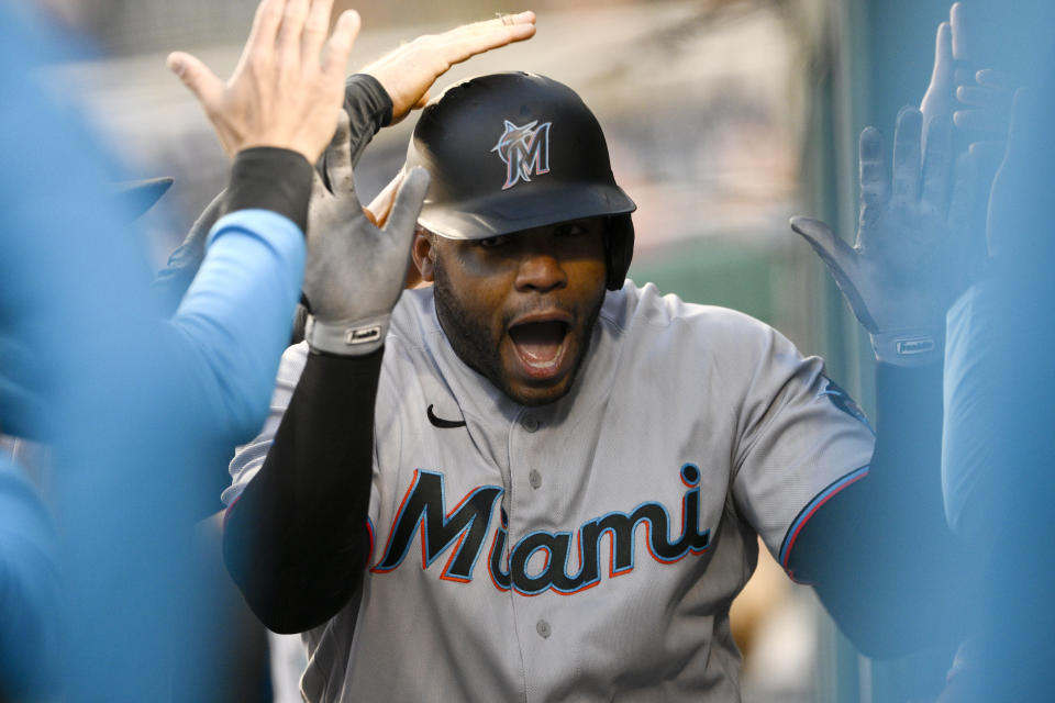 Miami Marlins' Jesus Aguilar celebrates his home run in the dugout during the third inning of a baseball game against the Washington Nationals, Wednesday, April 27, 2022, in Washington. (AP Photo/Nick Wass)