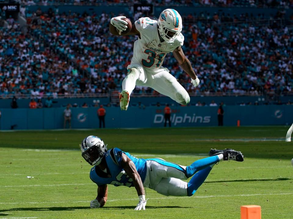 Raheem Mostert hurdles a defender.