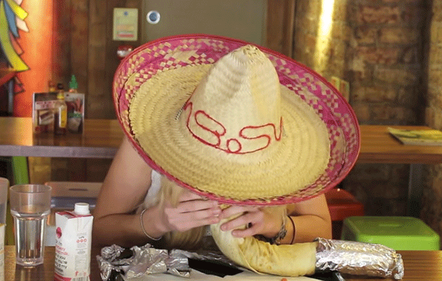 Kate Ovens munching on a triple-sized burrito. Photo: YouTube