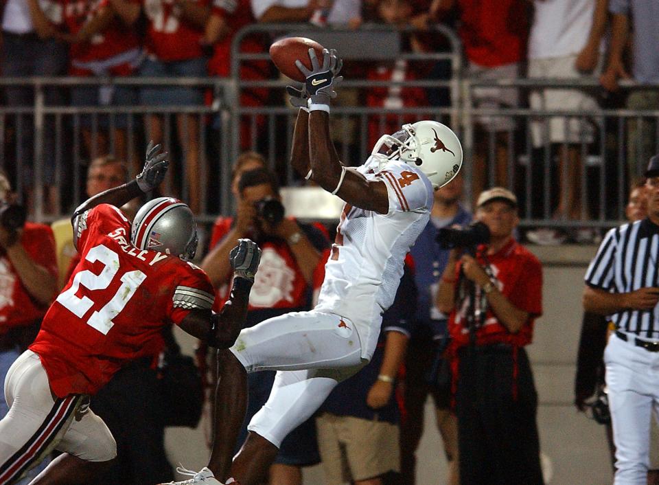 Texas receiver Limas Sweed catches the winning touchdown pass from Vince Young to beat Ohio State 25-22 in 2005, a monumental win that propelled Texas to a national title later that season. Young is mentoring quarterback Quinn Ewers, who just authored a 34-24 upset win at Alabama.