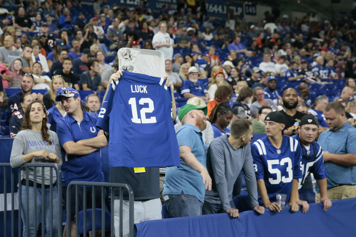 A fan holds up an Indianapolis Colts quarterback Andrew Luck jersey following the team's preseason game against the Bears on Saturday. (AP)