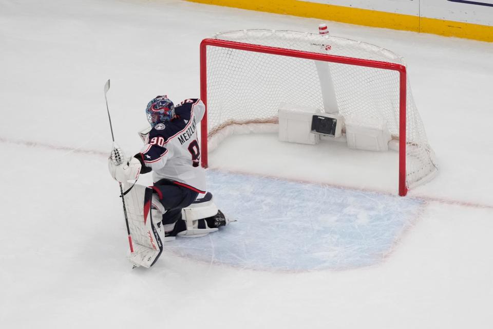 Columbus Blue Jackets goaltender Elvis Merzlikins celebrates a 1-0 victory over the St. Louis Blues following an NHL hockey game Tuesday, Jan. 30, 2024, in St. Louis. (AP Photo/Jeff Roberson)