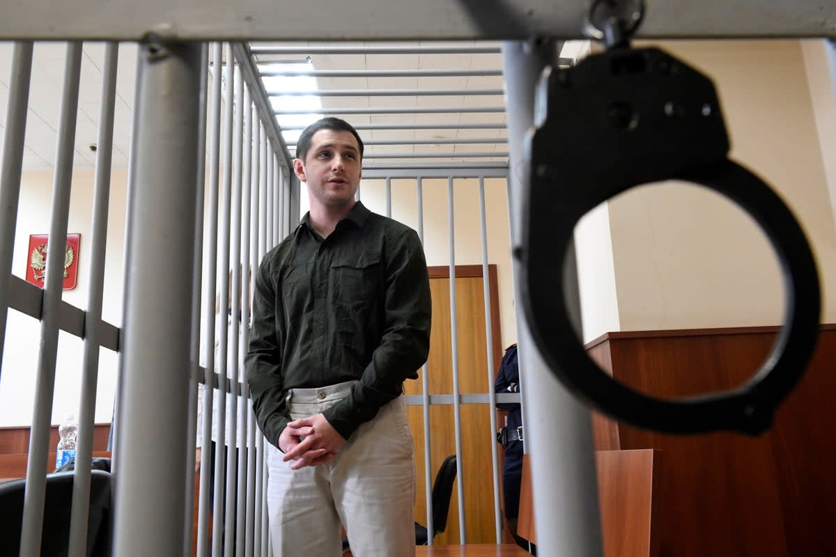 US ex-marine Trevor Reed, charged with attacking police, stands inside a defendants' cage during a court hearing in Moscow on March 11, 2020. (AFP via Getty Images)