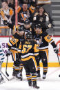 Pittsburgh Penguins' Evgeni Malkin celebrates with Sidney Crosby and Jake Guentzel after scoring during the first period of an NHL hockey game in Pittsburgh, Saturday, Jan. 28, 2023. (AP Photo/Gene J. Puskar)