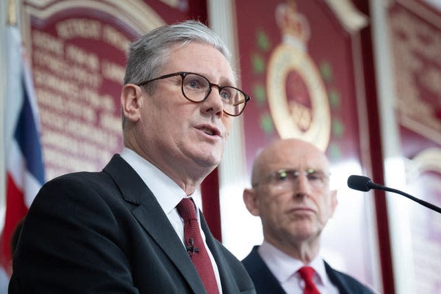 Labour Party leader Sir Keir Starmer speaks to an audience of military veterans watched by shadow defence secretary John Healey